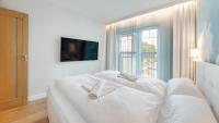 Posteľ alebo postele v izbe v ubytovaní Apartamenty Sun & Snow Port Krynica przy porcie i promenadzie