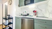 a kitchen with blue cabinets and a stainless steel dishwasher at Homey AWAY - Centre-ville &#47; Au Calme &#47; Proche des transports pour Genève in Annemasse