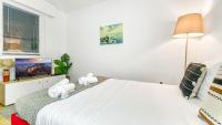 a white bedroom with a large bed and a window at Homey AWAY - Centre-ville &#47; Au Calme &#47; Proche des transports pour Genève in Annemasse