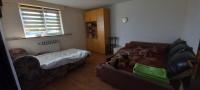 a living room with a couch and a bed at GM Place apartment 60 m2 in Gornji Milanovac