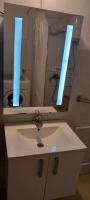 a bathroom with a white sink and a mirror at GM Place apartment 60 m2 in Gornji Milanovac