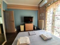 A bed or beds in a room at Ilias' cosy and relaxing apartment