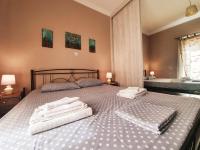 A bed or beds in a room at Ilias' cosy and relaxing apartment