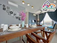 a dining room with a table with chairs and a table top group sign at D&#39;Pristine Design Apartment by TGP in Nusajaya