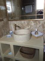 a bathroom counter with a sink and a mirror at Maison au bord de mer in Saintes-Maries-de-la-Mer