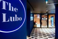a blue wall with the liloco sign in a room at The Lubo - self check-in in Luzern