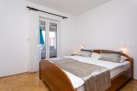 Postel nebo postele na pokoji v ubytování Apartments Crnekovic I Zarok
