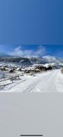 two pictures of a snow covered village with houses at Zlatna koliba Namir Zuka in Fojnica