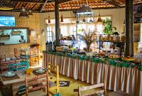 a kitchen with a table with food on it at Pousada Portal da Concha in Itacaré