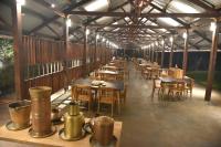 a row of tables and chairs in a restaurant at The Orchard Resort in Belgaum