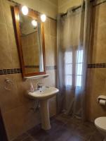 a bathroom with a sink and a shower with a mirror at Ta Majsi farmhouse with indoor heated pool in San Lawrenz