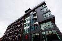 a tall black building with a red sign on it at JS HOTEL in Hat Yai