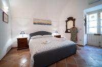 A bed or beds in a room at Gli Archi di Ortigia - Cala Rossa Cozy Apartment