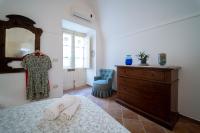 A bed or beds in a room at Gli Archi di Ortigia - Cala Rossa Cozy Apartment