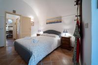 A bed or beds in a room at Gli Archi di Ortigia - Cala Rossa Cozy Apartment