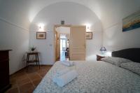 A bed or beds in a room at Gli Archi di Ortigia - Cala Rossa Cozy Apartment