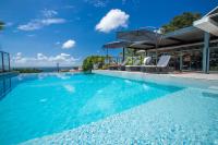 a swimming pool with blue water in a house at Karibea Squash Hôtel in Fort-de-France