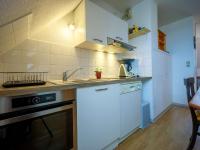 a kitchen with white cabinets and a sink at Appartement Saint-Lary-Soulan, 1 pièce, 6 personnes - FR-1-296-454 in Saint-Lary-Soulan