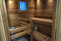 a sauna with wooden walls and a window at Villa Mustikkakumpu in Sonka