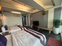 a hotel room with two beds and a fireplace at Ming Jun Homestay in Eluan