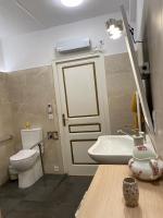a bathroom with a toilet and a sink and a door at Chez Hélène 3 étoiles, labellisé disabled PMR,pour 4 personnes chiens bienvenus-pet friendly in Bourg-Madame