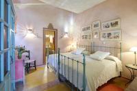 a bedroom with a bed and a table and a mirror at Cortijo La Hoya in El Bujeo