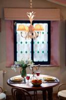 a dining room table with a chandelier and a window at Cortijo La Hoya in El Bujeo