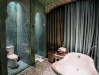a bathroom with a bath tub and a toilet at Kenting Amanda Hotel in Nanwan