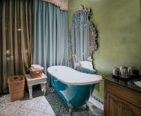 a bathroom with a blue tub and a sink at Kenting Amanda Hotel in Nanwan