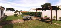 a picnic table and a bench in a backyard at Chambres d&#39;hôtes et gîtes Al Pati in Sorède