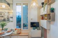 a living room with a large window and a table at Studio de charme à 2 pas de Paris in Malakoff