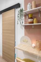 a kitchen with a shelf and a door at Studio de charme à 2 pas de Paris in Malakoff