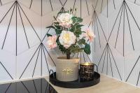 a vase with pink flowers on a table at Studio de charme à 2 pas de Paris in Malakoff