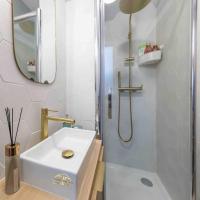 a white bathroom with a sink and a shower at Studio de charme à 2 pas de Paris in Malakoff