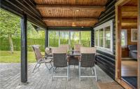 a screened in porch with a table and chairs at 2 Bedroom Lovely Home In Jgerspris in Hornsved