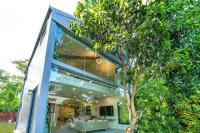 a glass house with a tree in front of it at Cloud Sun Homestay in Zhixue