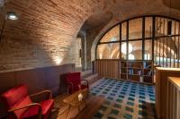 een kamer met een bakstenen muur en rode stoelen bij Le Marne Relais - Small Luxury Hotels of the World in Costigliole dʼAsti