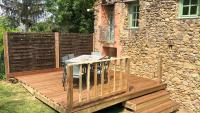 a wooden deck with a table and chairs on a building at Hameau de Montcabirol - Foix in Mirepoix