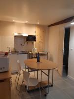 a kitchen with a table and chairs in a room at CHEZ ROSALIE 