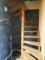 a wooden staircase in a room with a black wall at CHEZ ROSALIE 