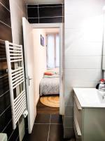 a small bathroom with a small bed and a window at Beau T2 hypercentre bien équipé in Quimper