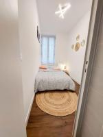 a small bedroom with a bed and a rug on the floor at Beau T2 hypercentre bien équipé in Quimper