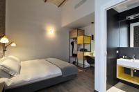 A bed or beds in a room at Atypical Rooms