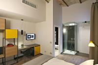 A bed or beds in a room at Atypical Rooms