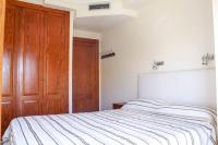 A bed or beds in a room at Apartamento Alcocebre Beach Resort