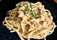a plate of pasta with meat and rosemary on it at Kenaray Farmstay riverside in Kaeng Krachan