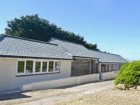 a house with a gray roof and a driveway at Bowji in St. Just