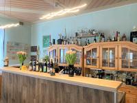 シュミーデフェルト・アム・レンシュタイクにあるHotel Zur Henneのボトルと花が飾られたバーのある部屋