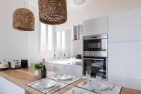 a kitchen with a counter with two plates on it at Belle vue sur mer, très près du port de Sanary in Sanary-sur-Mer