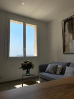 a living room with a couch and a window at Belle vue sur mer, très près du port de Sanary in Sanary-sur-Mer